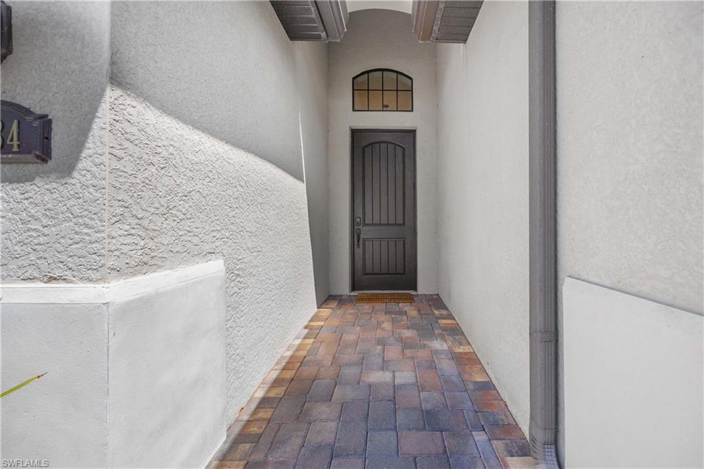 9234 Veneto Place Naples, FL 34113 - Photo 20 of 38 a view of empty room with wooden floor