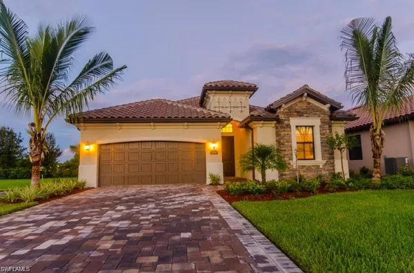 a front view of a house with a yard and garage