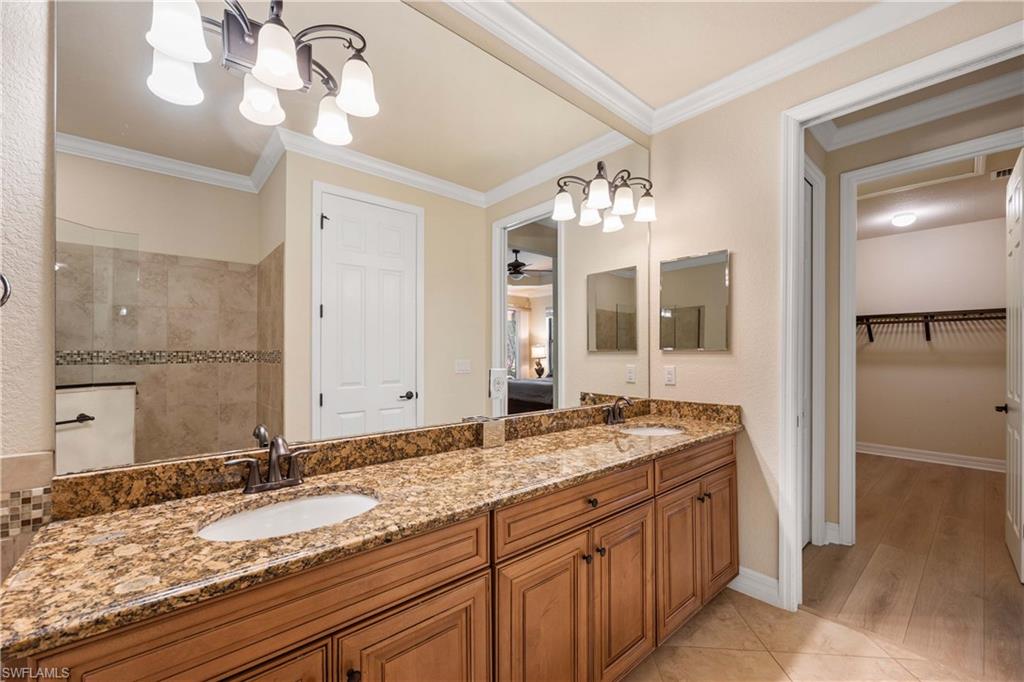 9234 Veneto Place Naples, FL 34113 - Photo 21 of 38 a bathroom with a granite countertop sink and a mirror