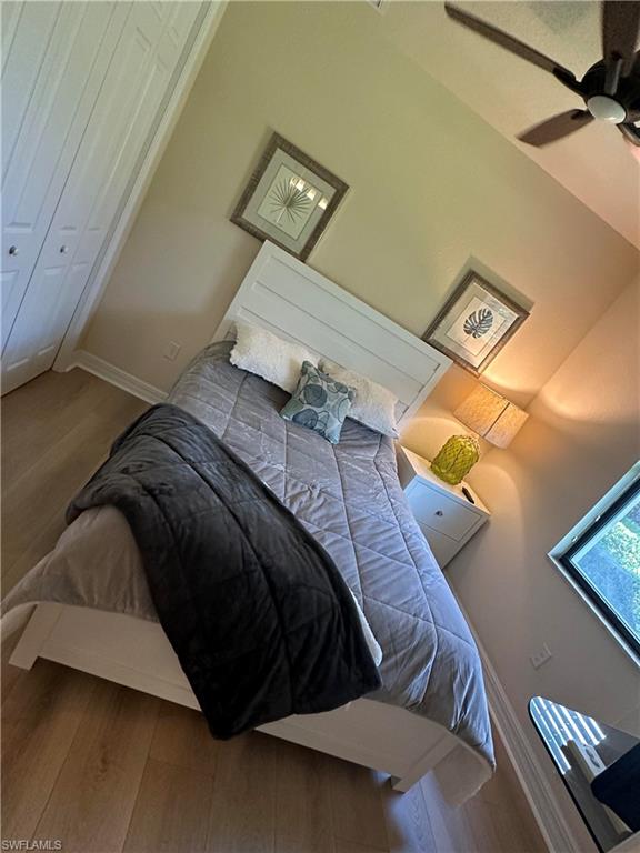 9234 Veneto Place Naples, FL 34113 - Photo 25 of 38 a bedroom with a bed and a lamp