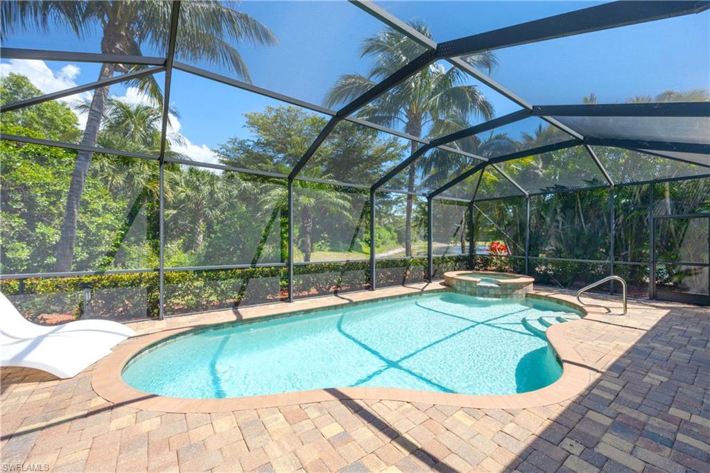 9234 Veneto Place Naples, FL 34113 - Photo 27 of 38 a view of a swimming pool with a patio