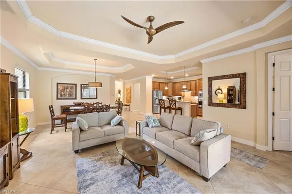 a living room with furniture a flat screen tv and a table