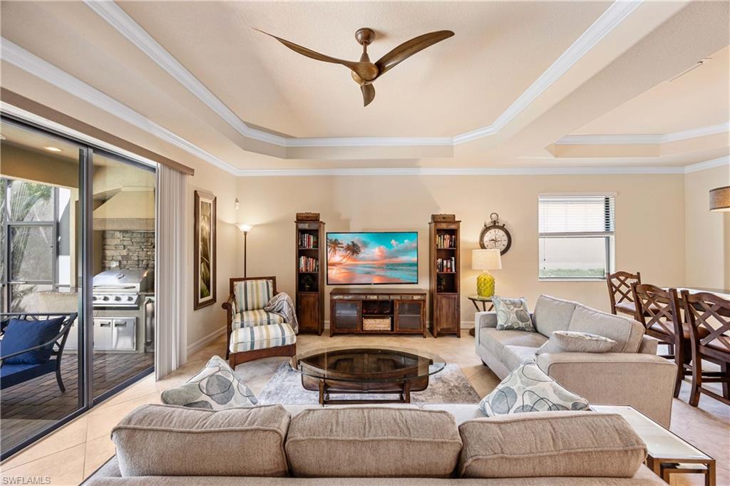 9234 Veneto Place Naples, FL 34113 - Photo 9 of 38 a living room with furniture and a flat screen tv