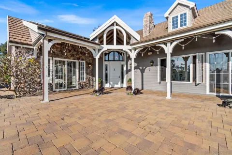 a view of a hallway with wooden shelves and front door
