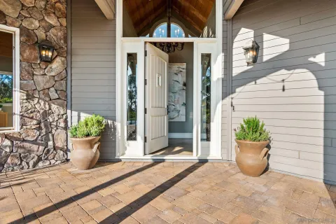 a view of a room with wooden floor and white walls