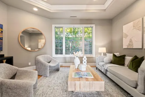 a living room with fireplace furniture and a large window