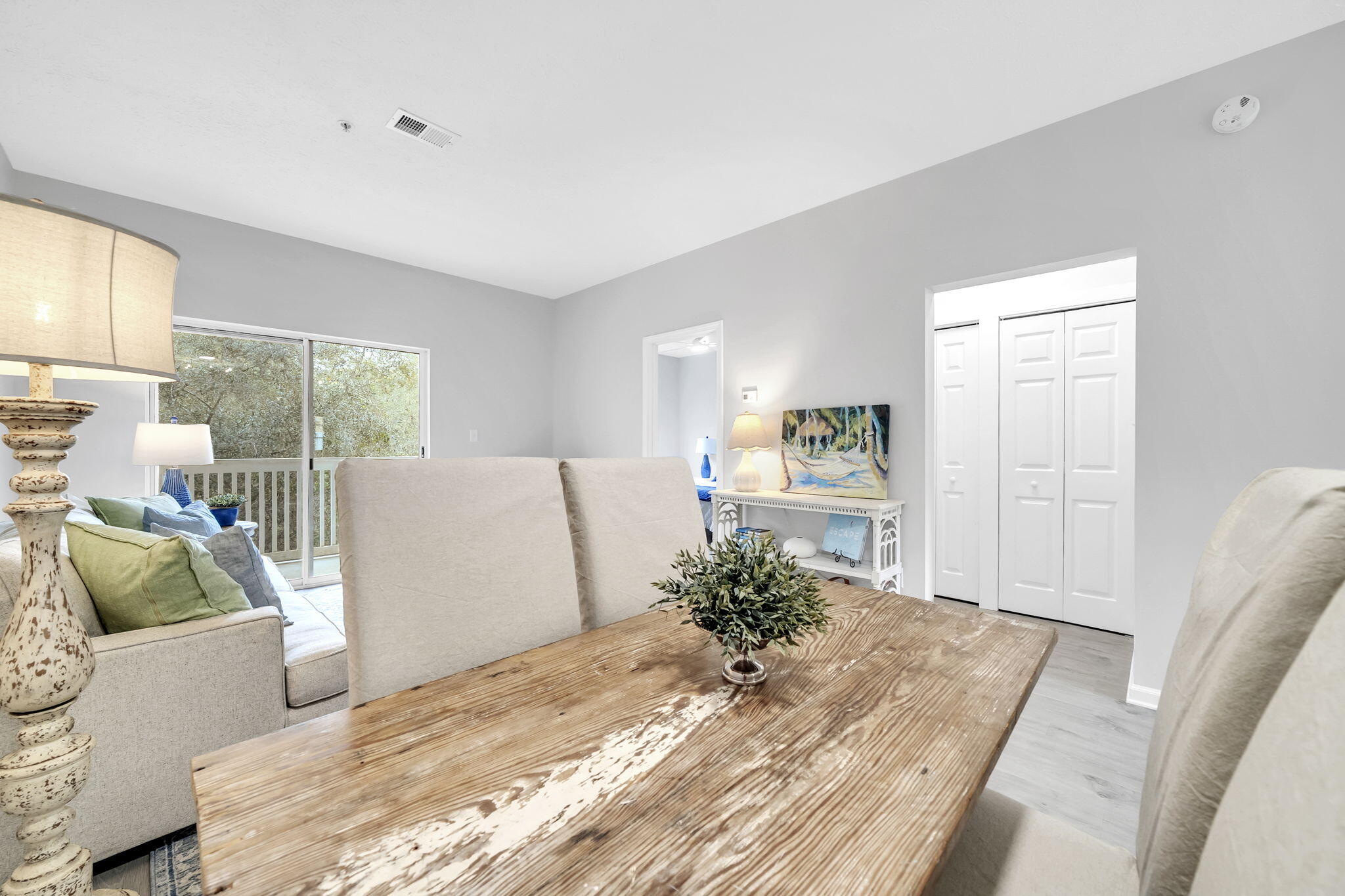 34 Heron's Watch Way, Unit 1202 Santa Rosa Beach, FL 32459 - Photo 15 of 36 a living room with a couch and a table with wooden floor