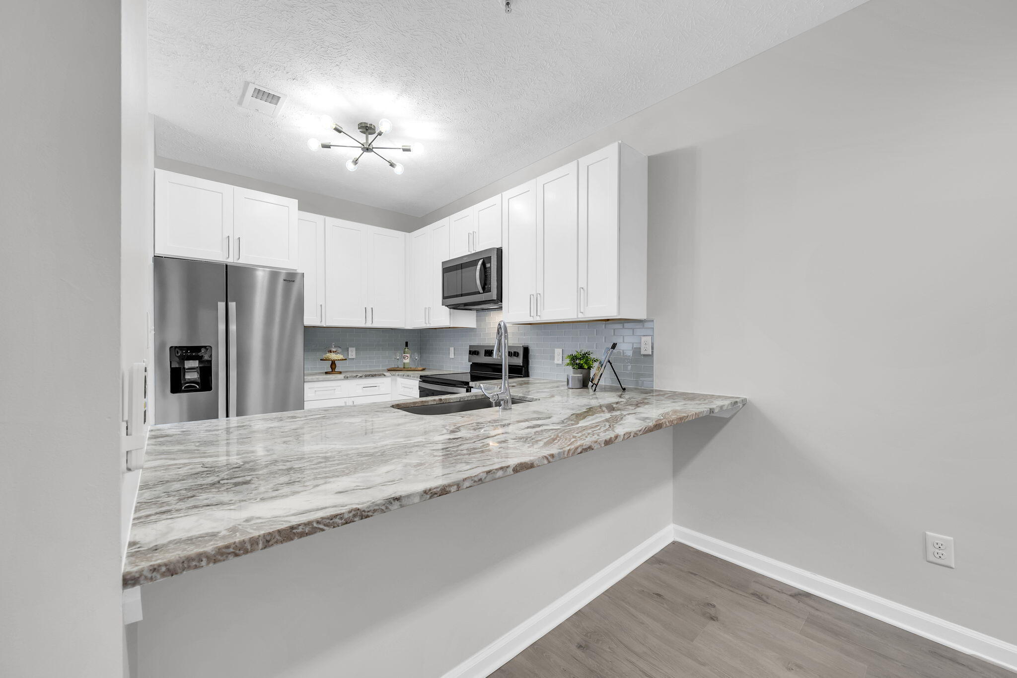 34 Heron's Watch Way, Unit 1202 Santa Rosa Beach, FL 32459 - Photo 2 of 36 a view of a kitchen with a sink a refrigerator and a stove top oven