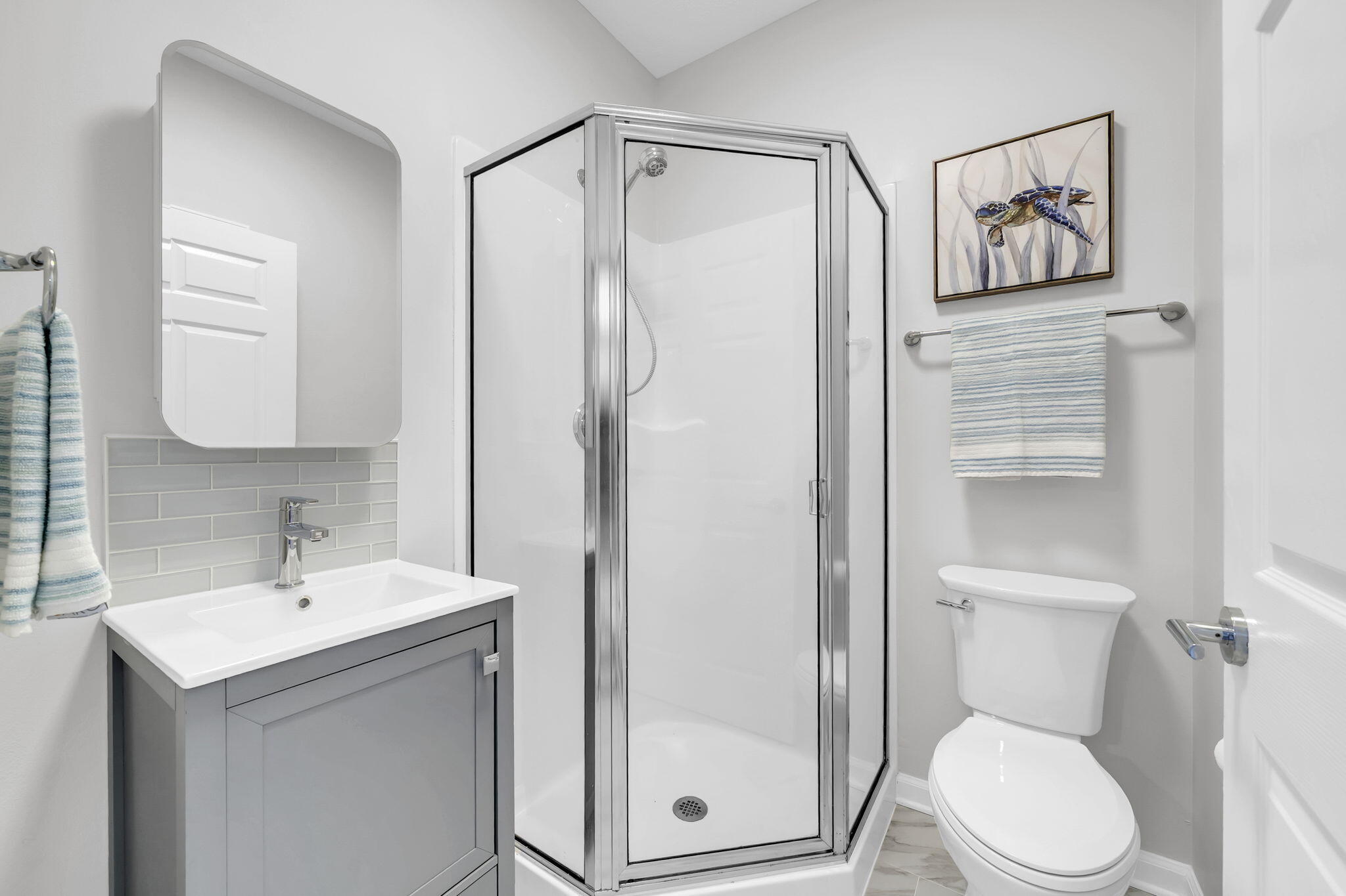 34 Heron's Watch Way, Unit 1202 Santa Rosa Beach, FL 32459 - Photo 21 of 36 a bathroom with a toilet a sink and glass door