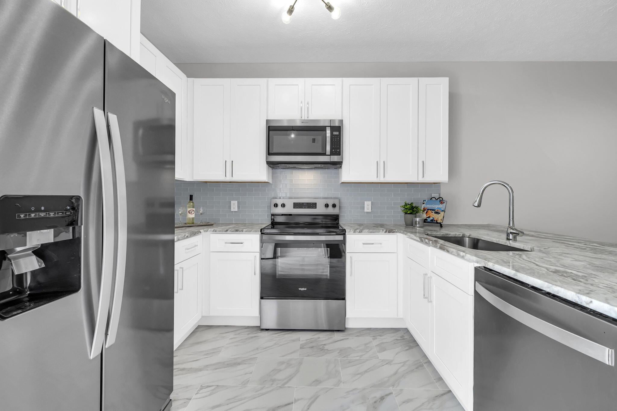 34 Heron's Watch Way, Unit 1202 Santa Rosa Beach, FL 32459 - Photo 9 of 36 a kitchen with stainless steel appliances granite countertop a refrigerator stove and sink