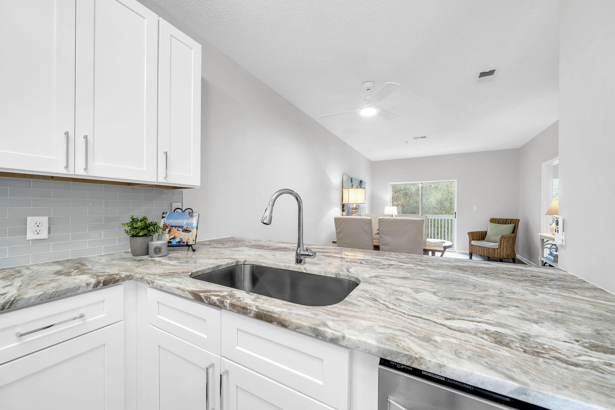 34 Heron's Watch Way, Unit 1202 Santa Rosa Beach, FL 32459 - Photo 10 of 36 a kitchen with granite countertop a sink and white cabinets