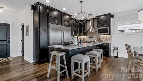 a kitchen with stainless steel appliances a stove sink and cabinets