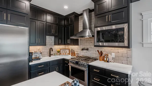 a kitchen with stainless steel appliances granite countertop a sink and cabinets