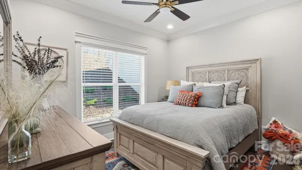 a living room with furniture kitchen view and a chandelier