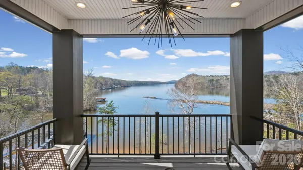a bathroom with a white tub a mirror and a window