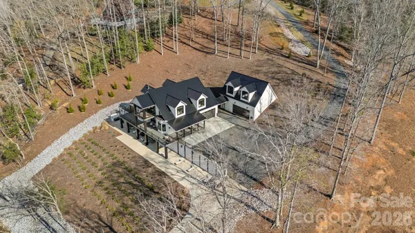 a view of a backyard with wooden floor and fence