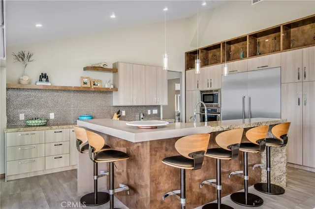 a kitchen with a table chairs sink and cabinets
