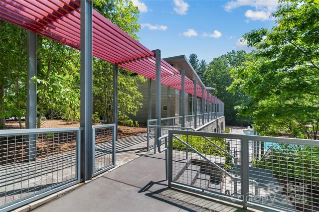 a view of swimming pool with lounge chairs in patio