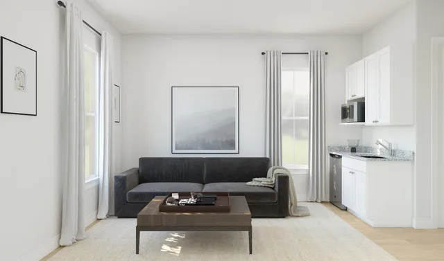 a living room with furniture and white appliances
