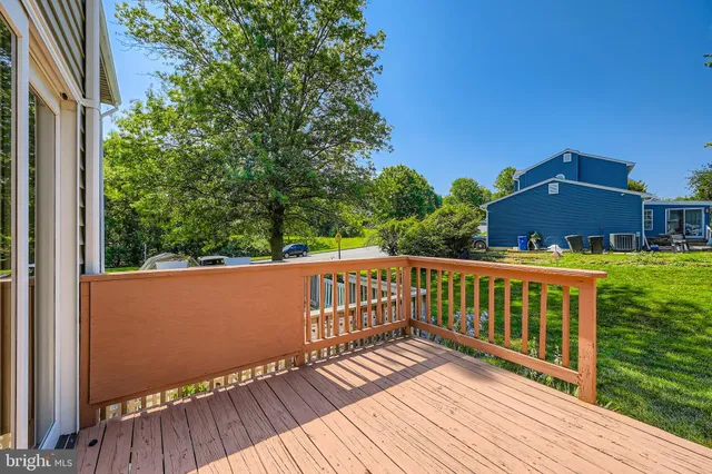 a view of balcony with wooden floor and fence