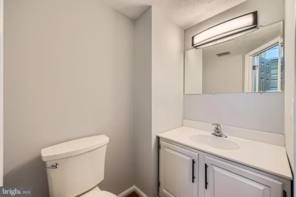 a bathroom with a sink toilet and a mirror