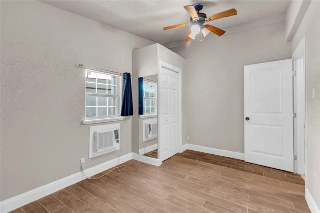 a bathroom with a granite countertop sink a toilet and a mirror