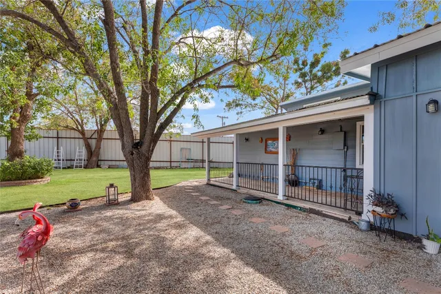 a view of a house with a yard and tree