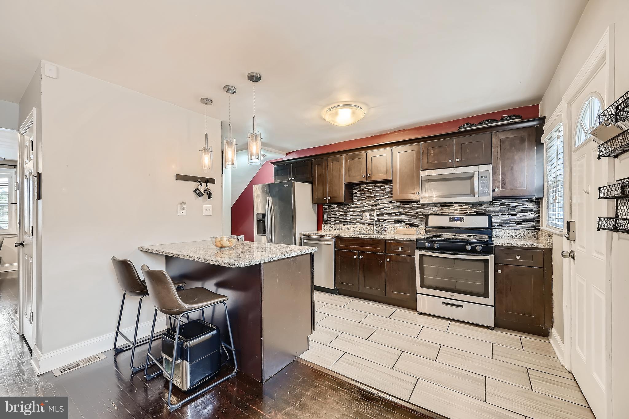 3828 Ednor Road Baltimore, MD 21218 - Photo 11 of 27 a kitchen with stainless steel appliances a stove a sink refrigerator and a microwave