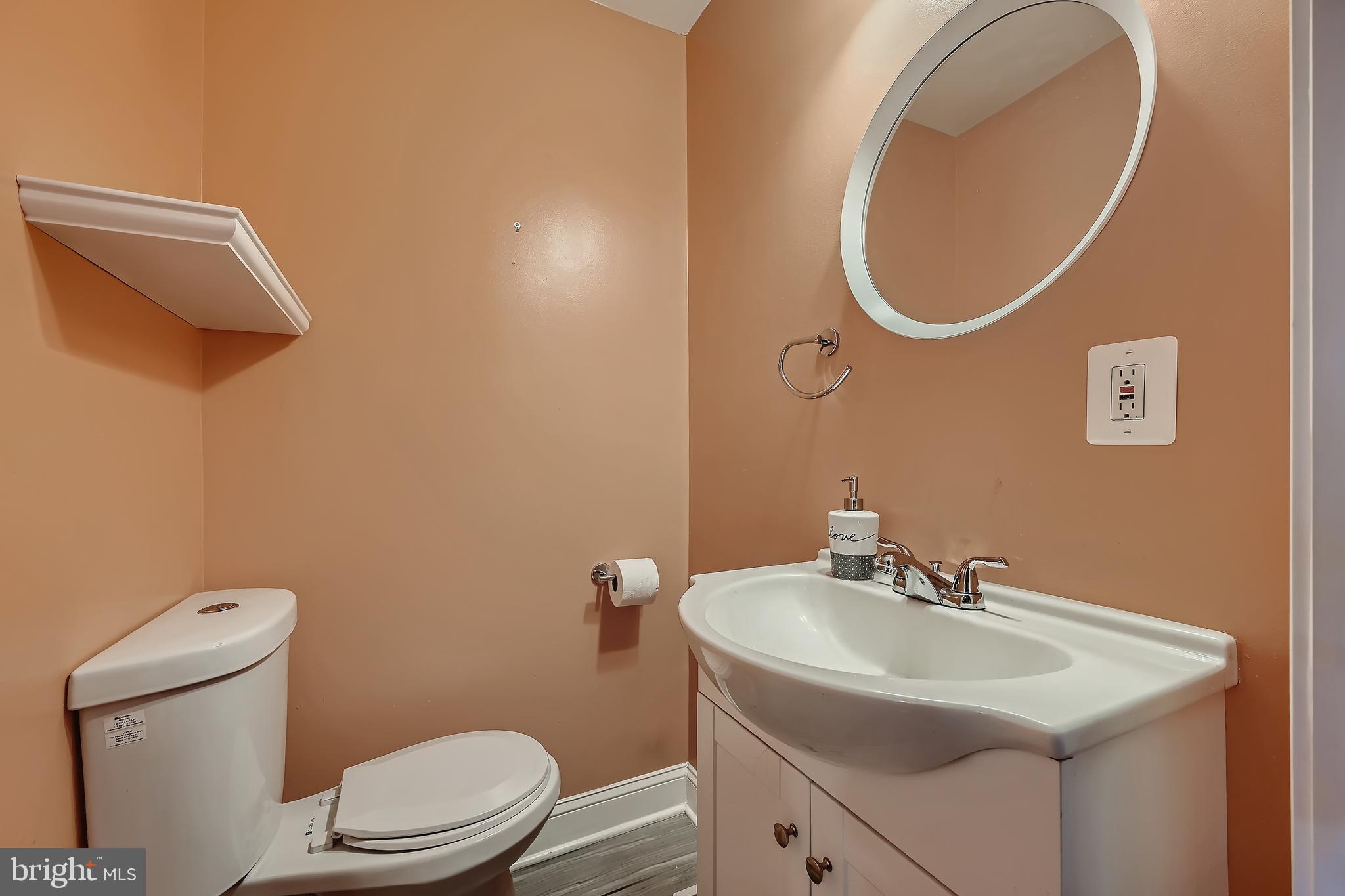 3828 Ednor Road Baltimore, MD 21218 - Photo 15 of 27 a bathroom with a sink mirror vanity and toilet