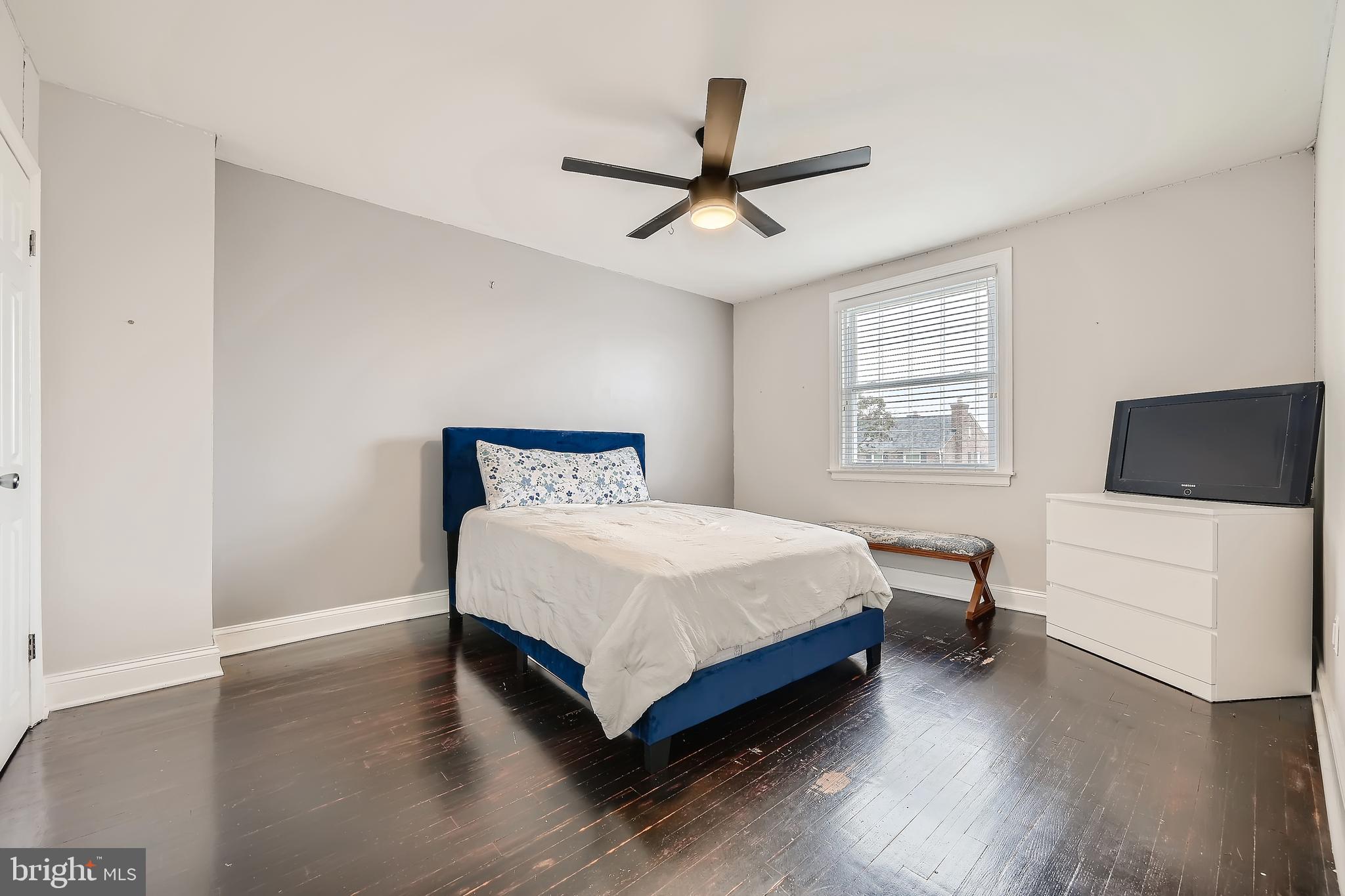 3828 Ednor Road Baltimore, MD 21218 - Photo 16 of 27 a bedroom with a bed and a flat screen tv