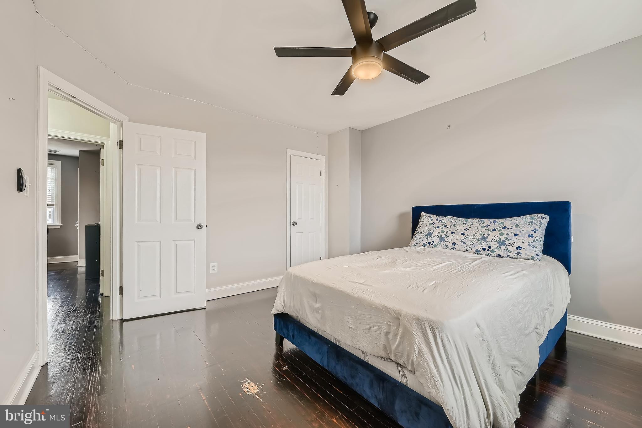 3828 Ednor Road Baltimore, MD 21218 - Photo 17 of 27 a bedroom with a bed and a chandelier