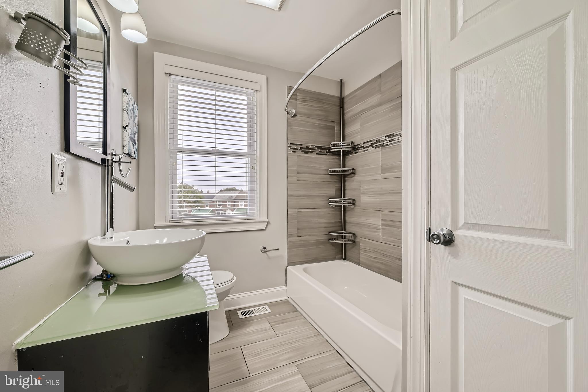 3828 Ednor Road Baltimore, MD 21218 - Photo 18 of 27 a bathroom with a bathtub and a shower