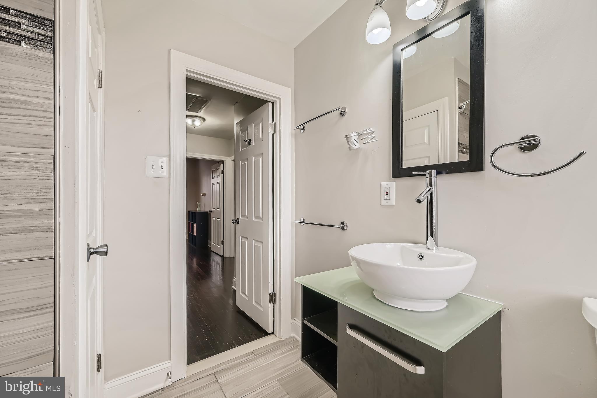 3828 Ednor Road Baltimore, MD 21218 - Photo 19 of 27 a bathroom with a sink and a mirror