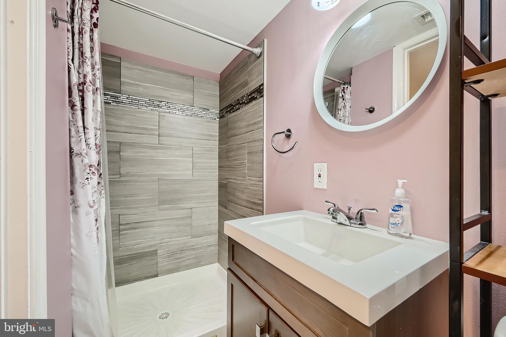 3828 Ednor Road Baltimore, MD 21218 - Photo 24 of 27 a bathroom with a sink vanity and a mirror