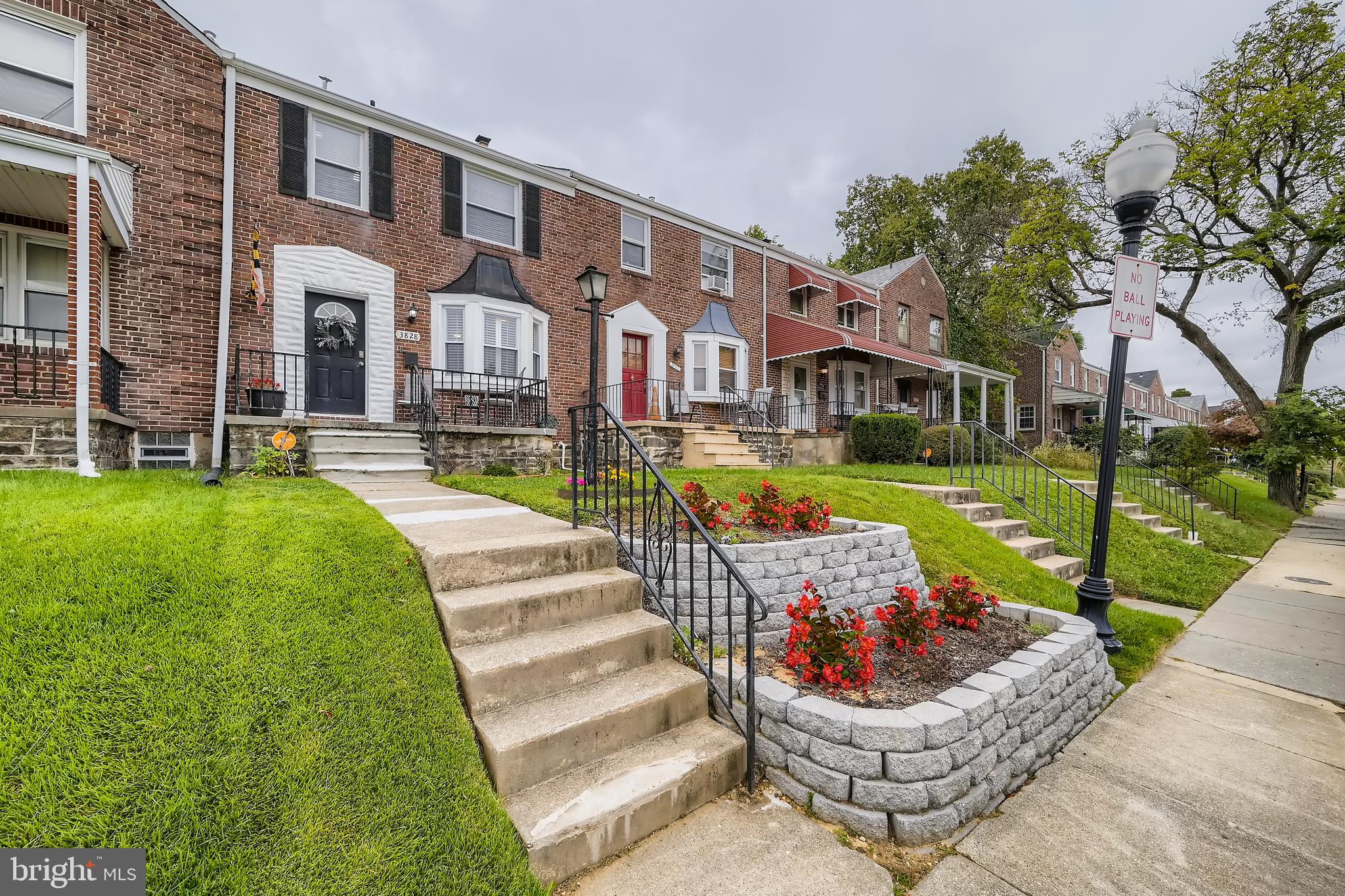 3828 Ednor Road Baltimore, MD 21218 - Photo 3 of 27 a front view of a house with a garden and plants