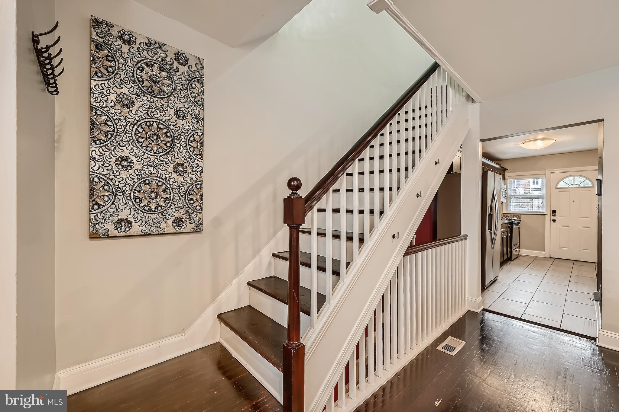 3828 Ednor Road Baltimore, MD 21218 - Photo 5 of 27 a view of staircase with white walls and a window