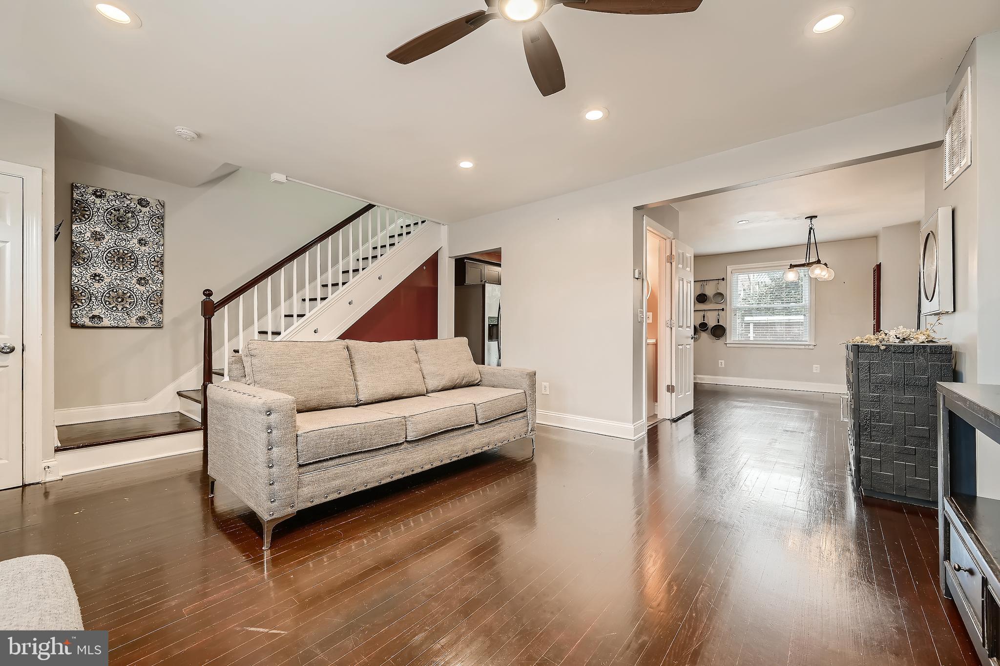 3828 Ednor Road Baltimore, MD 21218 - Photo 6 of 27 a living room with furniture and a chandelier