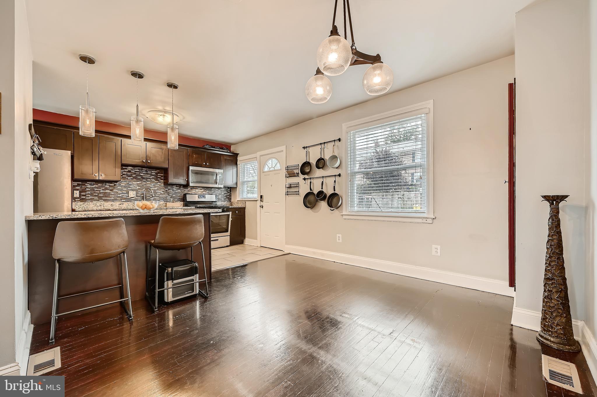 3828 Ednor Road Baltimore, MD 21218 - Photo 8 of 27 a living room with stainless steel appliances kitchen island granite countertop furniture and a kitchen view