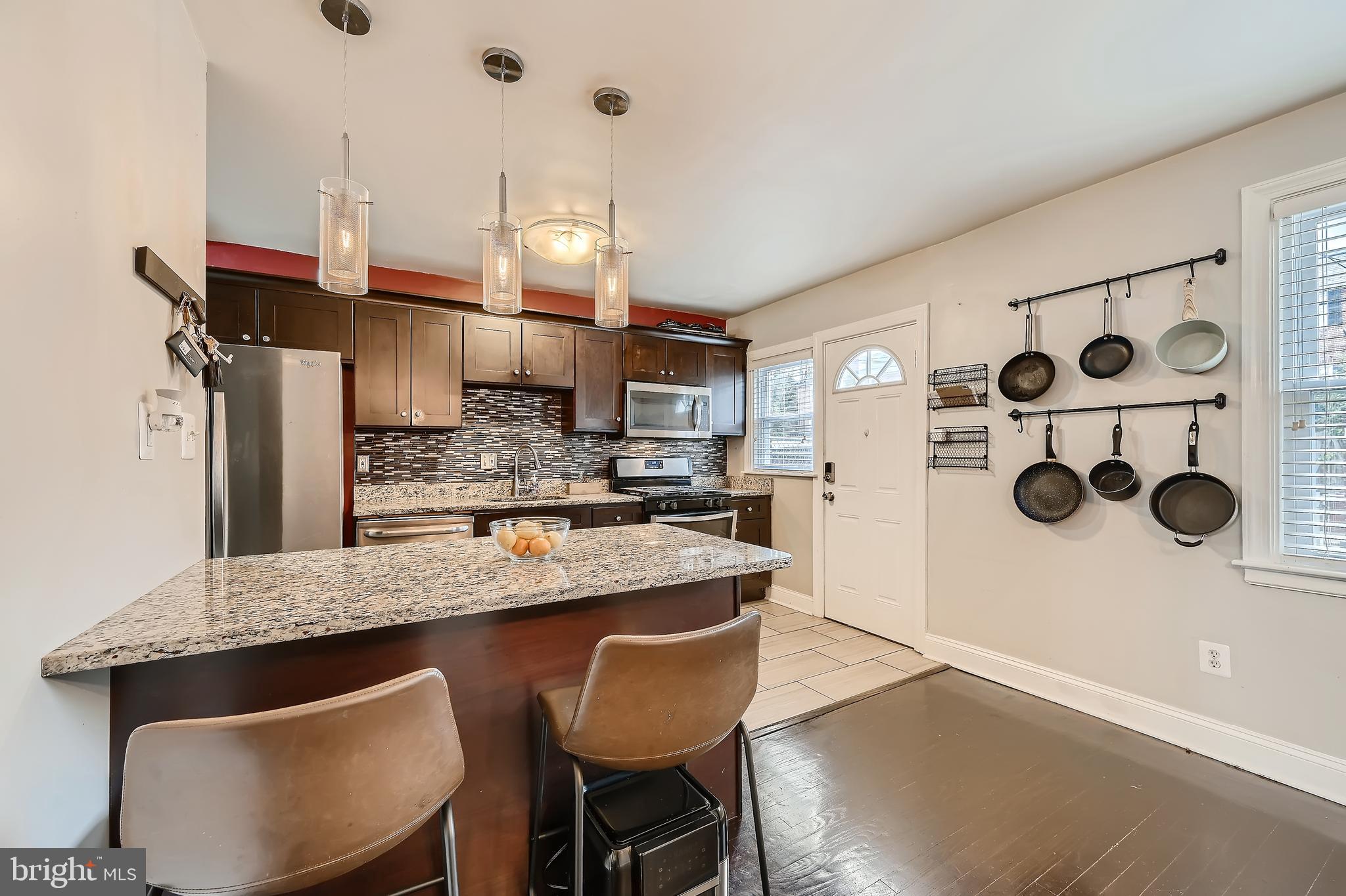 3828 Ednor Road Baltimore, MD 21218 - Photo 10 of 27 a kitchen with stainless steel appliances granite countertop a sink a stove and a refrigerator