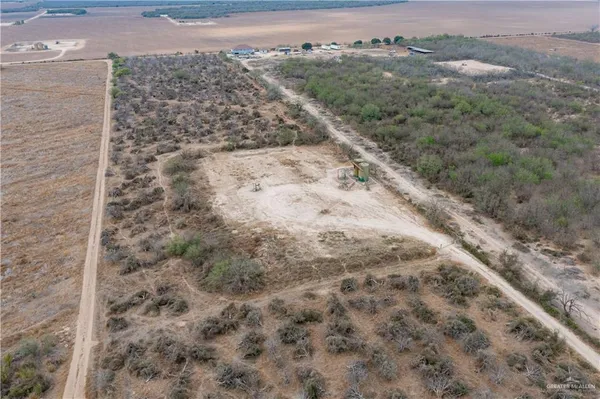 a view of a dry yard with mountains and green space