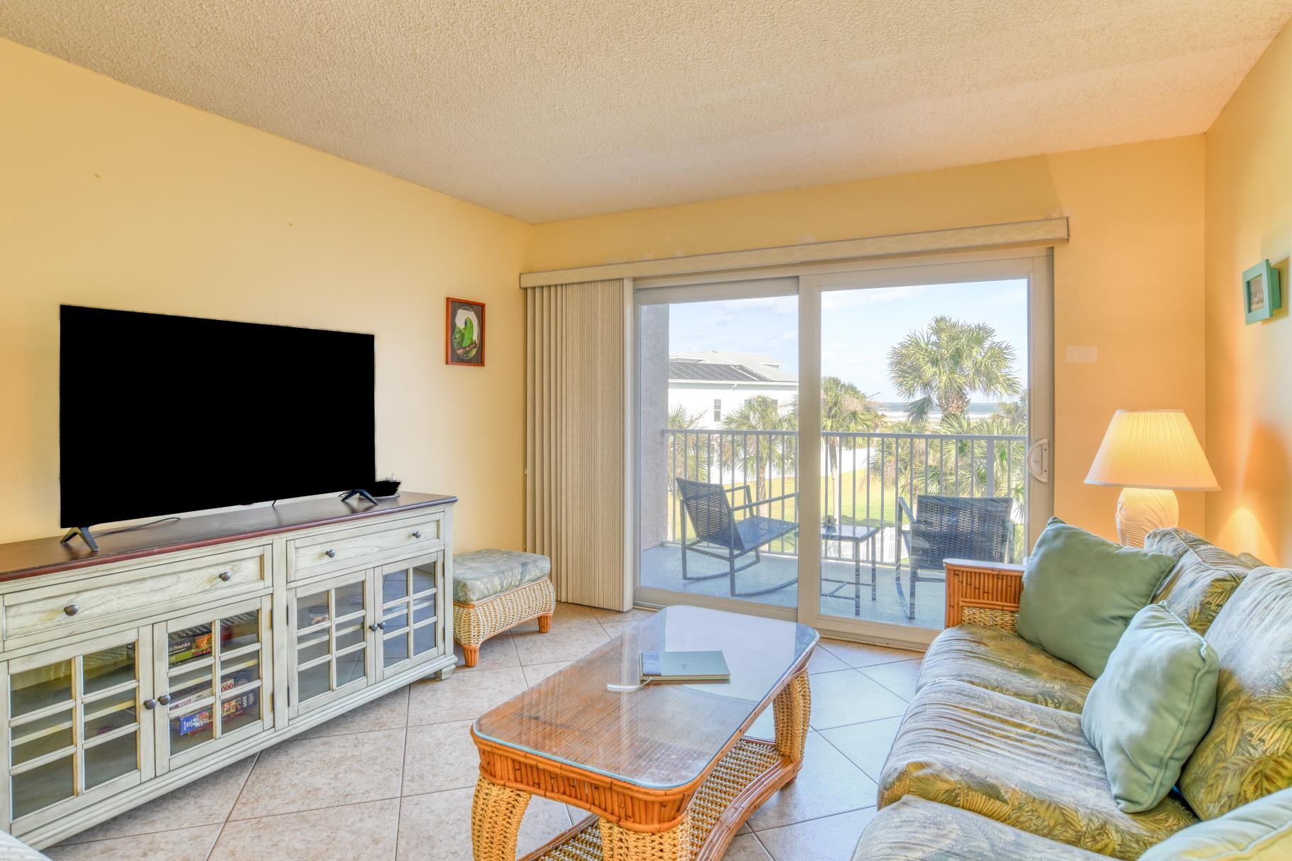 4 Ocean Trace Road, Unit 323 St. Augustine Beach, FL 32080 - Photo 11 of 37 a living room with furniture and a flat screen tv