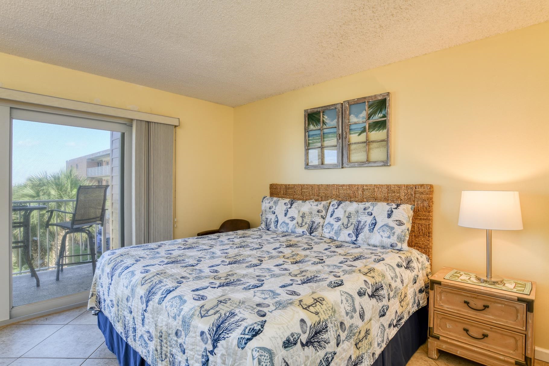 4 Ocean Trace Road, Unit 323 St. Augustine Beach, FL 32080 - Photo 15 of 37 a bedroom with a bed and a night stand