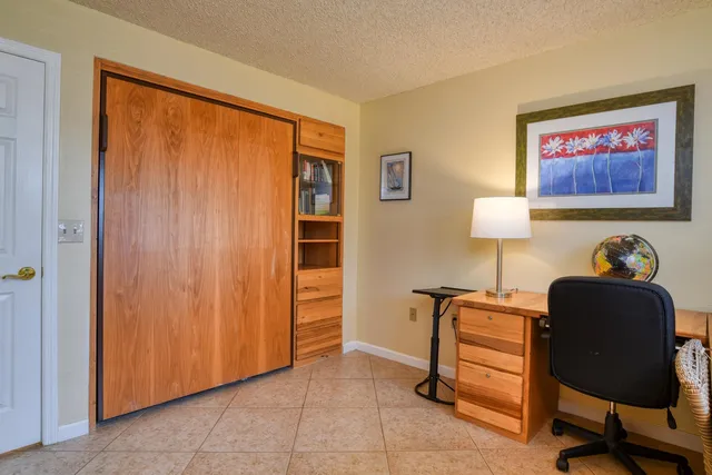 a bedroom with a bed dresser and a window