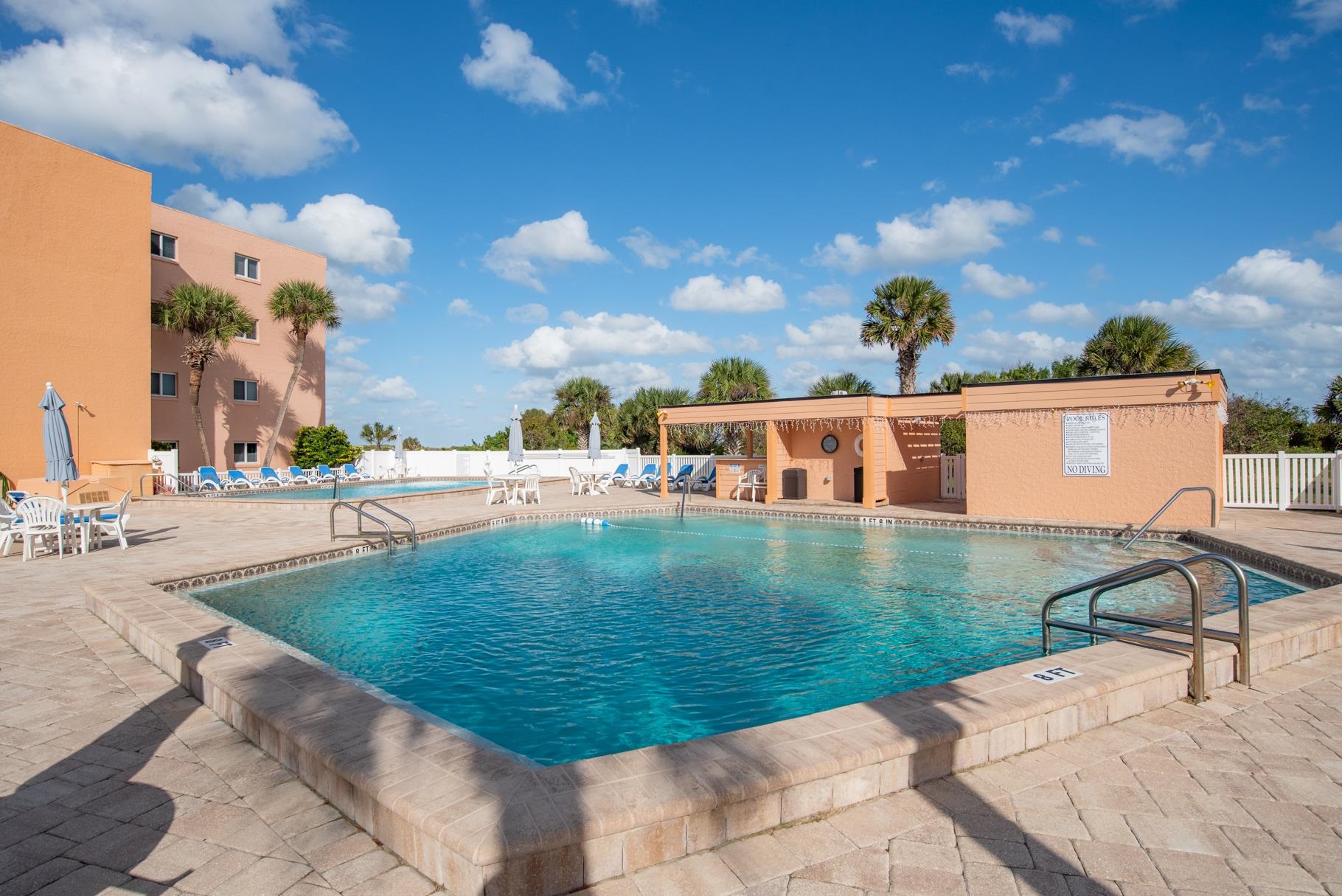 4 Ocean Trace Road, Unit 323 St. Augustine Beach, FL 32080 - Photo 28 of 37 a view of a swimming pool with a yard