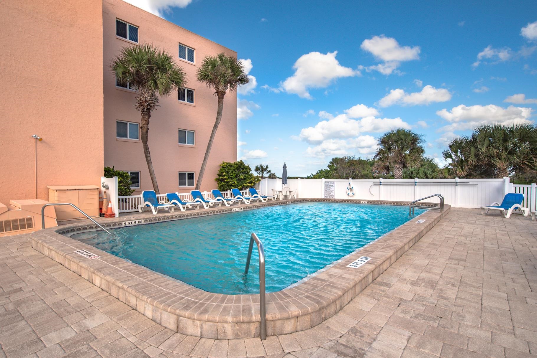 4 Ocean Trace Road, Unit 323 St. Augustine Beach, FL 32080 - Photo 29 of 37 a view of a swimming pool with a yard