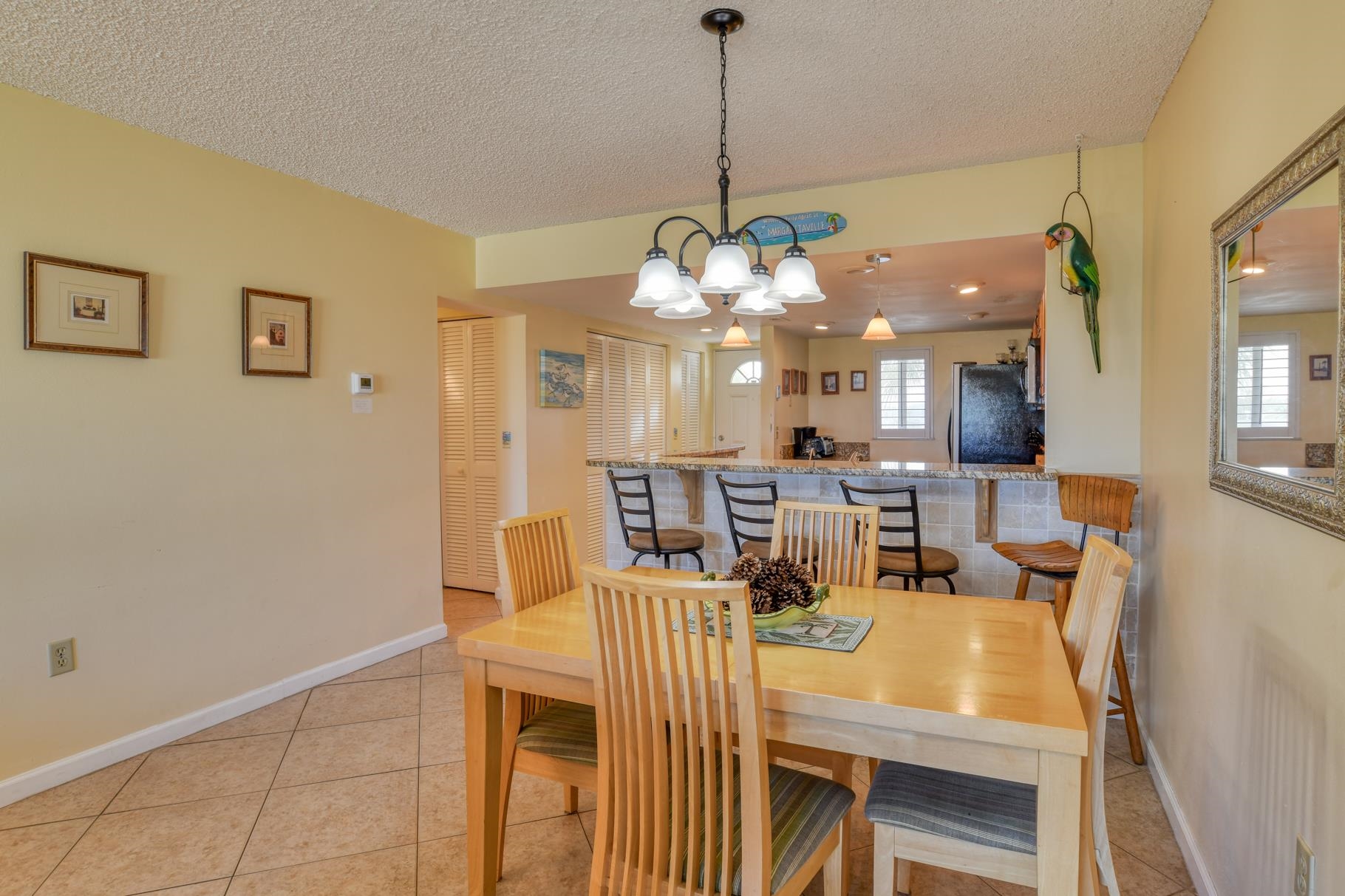 4 Ocean Trace Road, Unit 323 St. Augustine Beach, FL 32080 - Photo 7 of 37 a view of a dining room with furniture and a chandelier