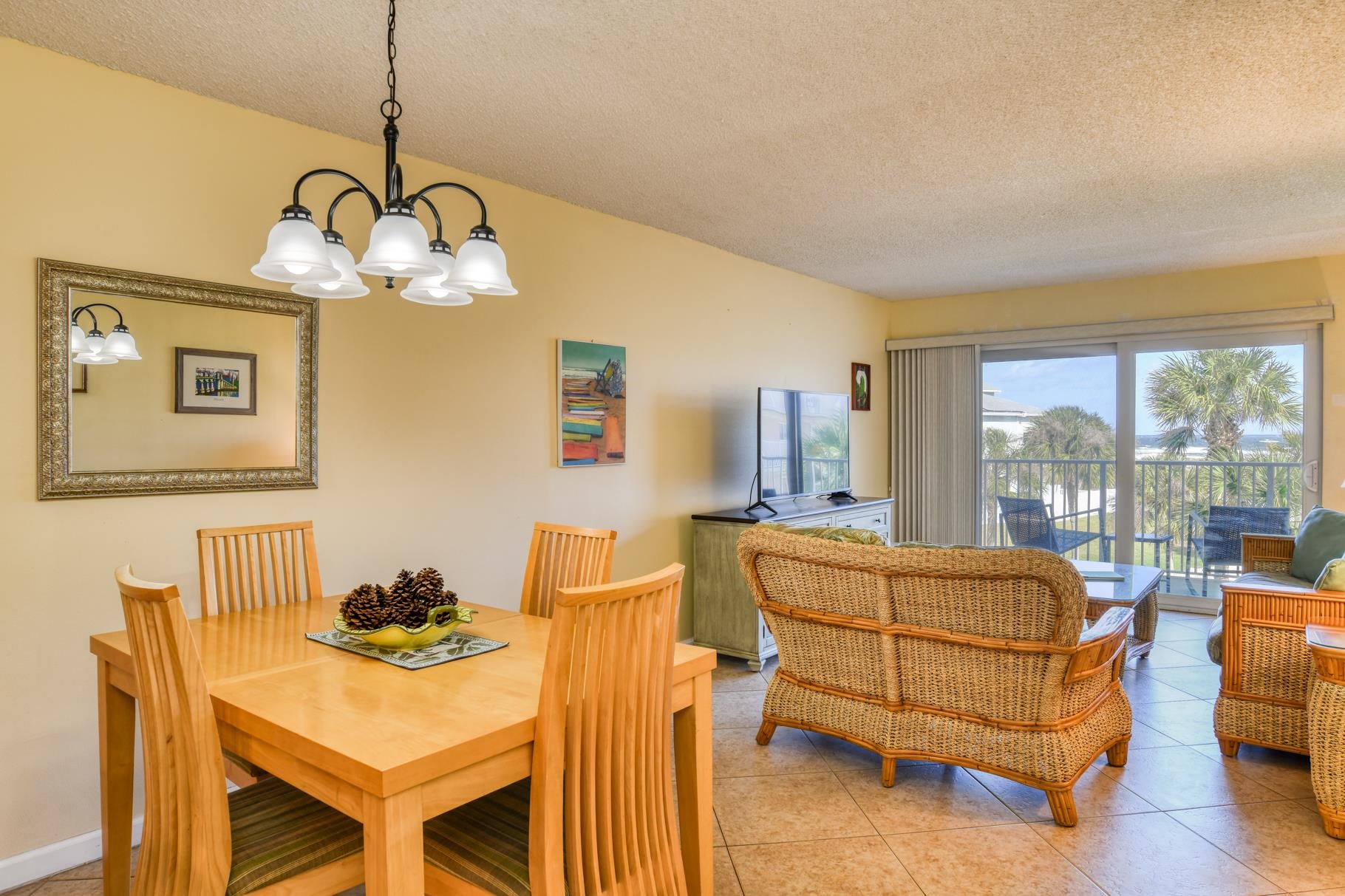 4 Ocean Trace Road, Unit 323 St. Augustine Beach, FL 32080 - Photo 8 of 37 a living room with furniture and a chandelier