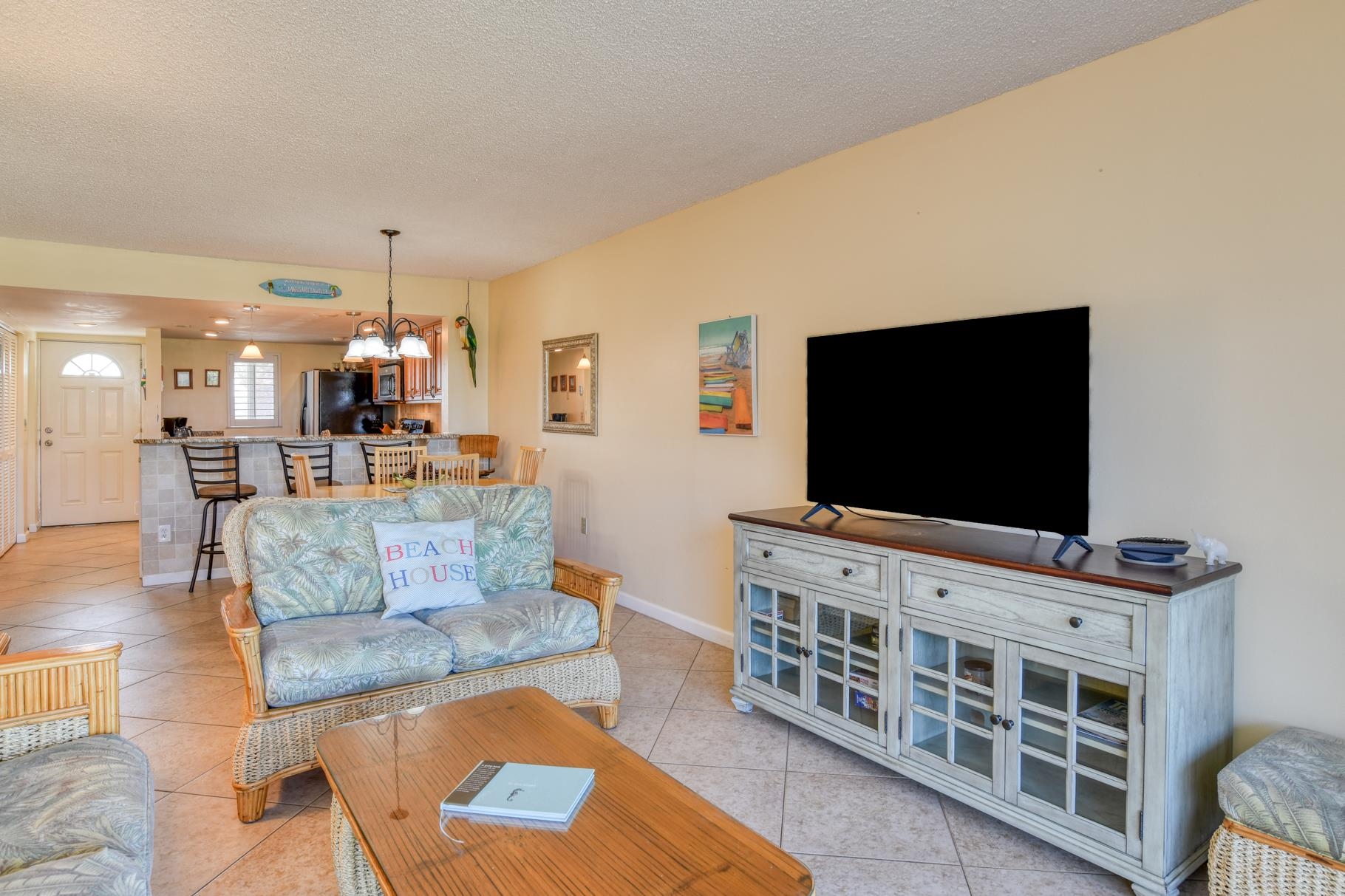 4 Ocean Trace Road, Unit 323 St. Augustine Beach, FL 32080 - Photo 9 of 37 a living room with furniture and a flat screen tv