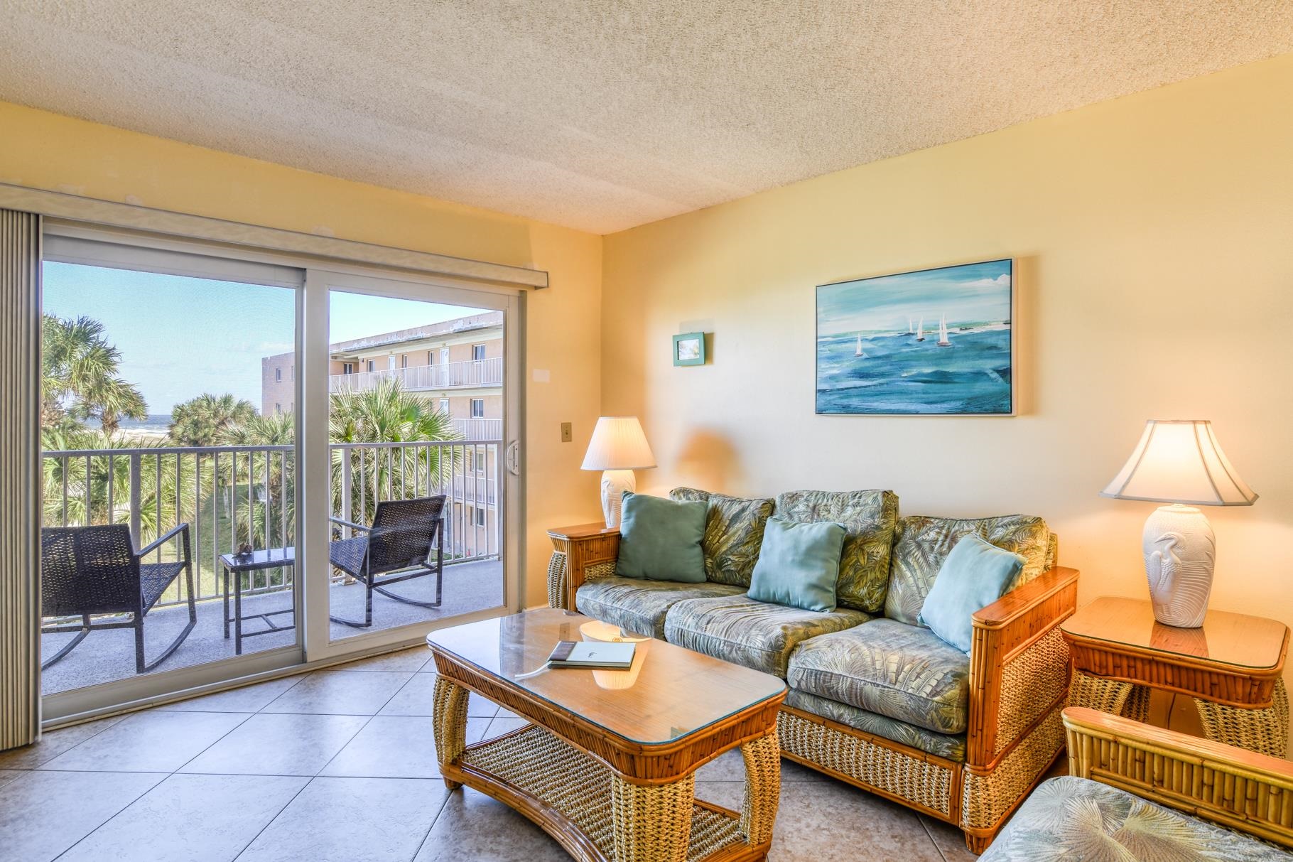 4 Ocean Trace Road, Unit 323 St. Augustine Beach, FL 32080 - Photo 10 of 37 a living room with furniture and a large window