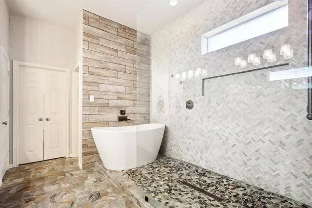 a bathroom with a bathtub and shower